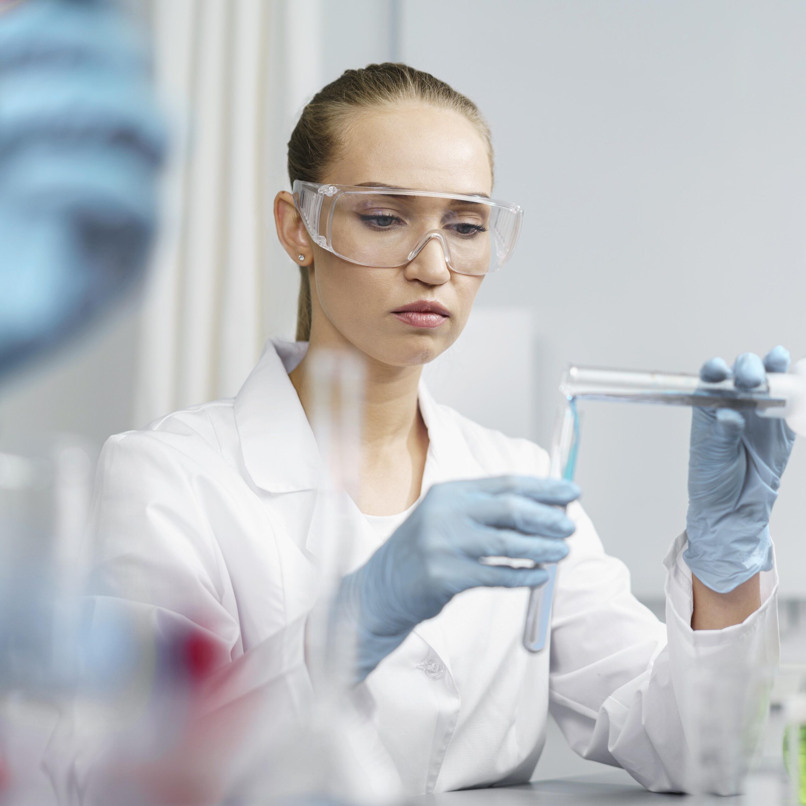 front-view-female-researcher-laboratory-with-test-tubes-safety-glasses