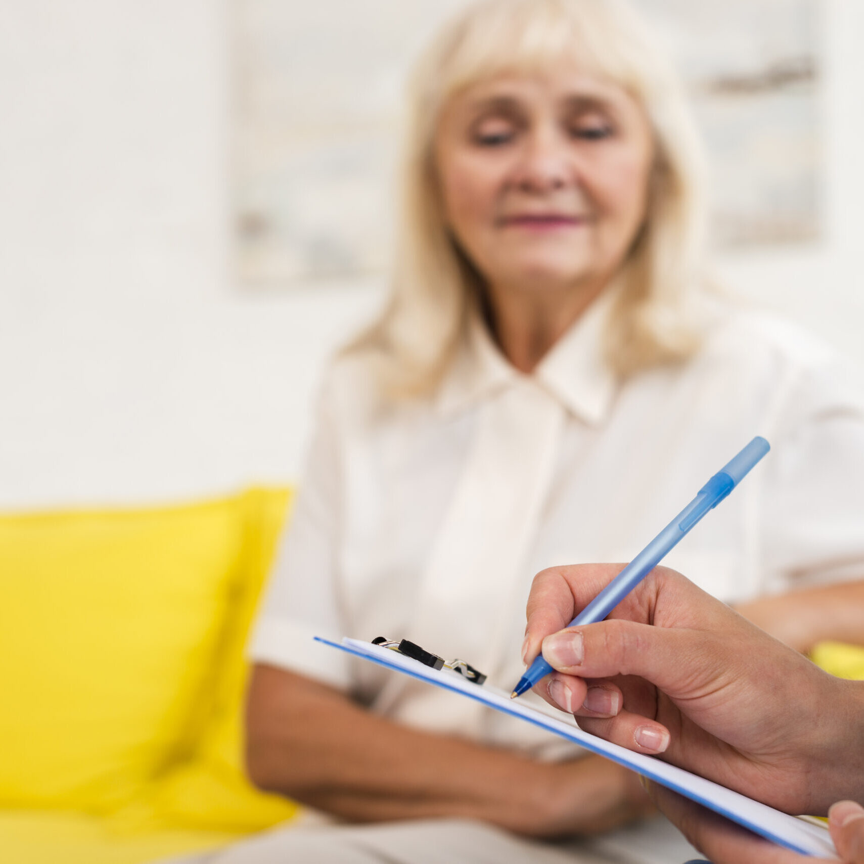 caregiver-writing-clipboard-close-up